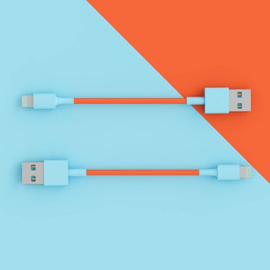 Düz bir zeminde iki renkli mavi ve mercan usb kablosu uzanır.