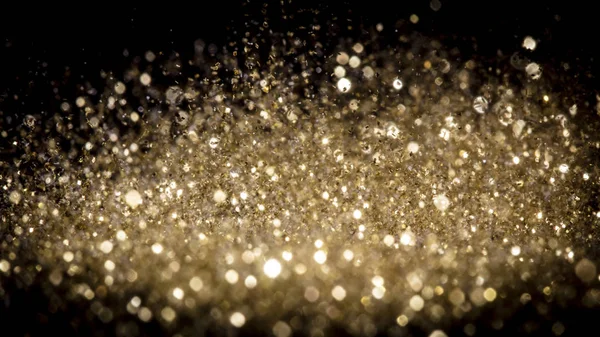 Esplosione di polvere d'oro scintillante su sfondo nero . — Foto Stock