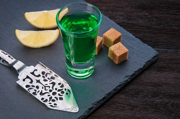 Alcohol Absinthe drink with a sugar cubes, spoon and lemon slice — Stock Photo, Image