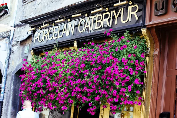 Ljubljana, shop sign decorated with red flowers