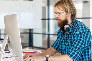 Genç adam ofiste çalışıyor.