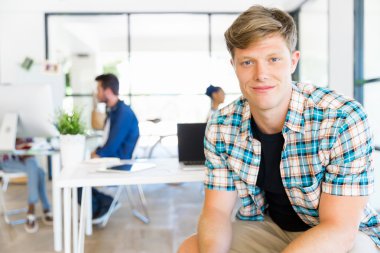 Genç adam ofiste çalışıyor.