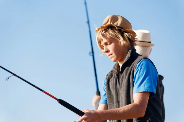 Tiener jongen vissen op zee — Stockfoto