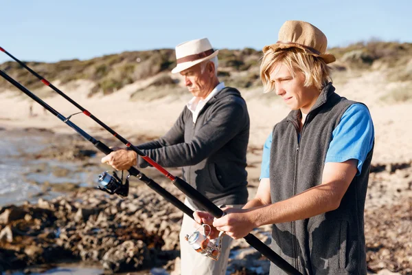 Senior man fishing with his grandson — Stock Photo, Image