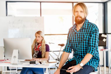 Genç adam ofiste çalışıyor.