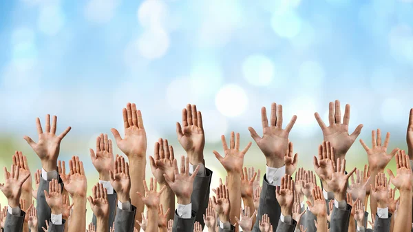 Group of people with raised hands . Mixed media — Stock Photo, Image