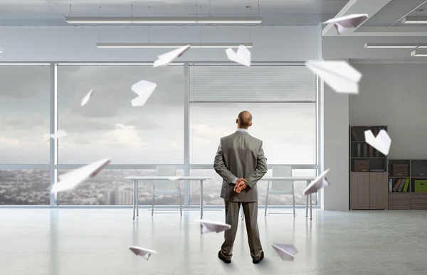 Pensive businessman in office . Mixed media — Stock Photo, Image