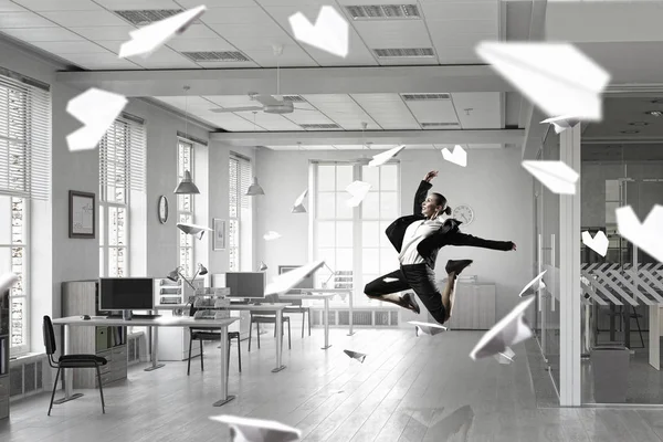 Dancing businesswoman in office room . Mixed media — Stock Photo, Image