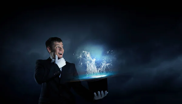 Businessman demonstrating magic . Mixed media — Stock Photo, Image