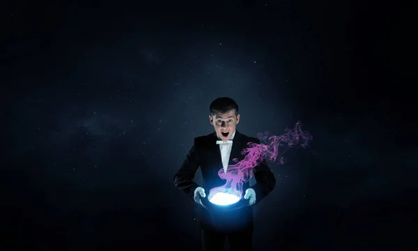 Businessman demonstrating magic . Mixed media — Stock Photo, Image