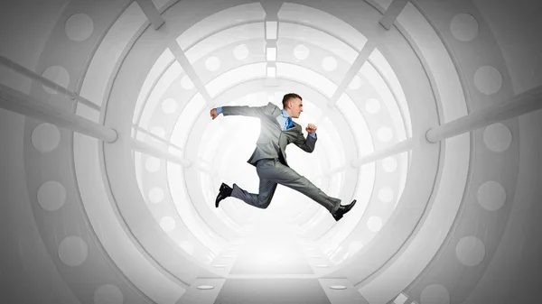 Jumping businessman in virtual room . Mixed media — Stock Photo, Image