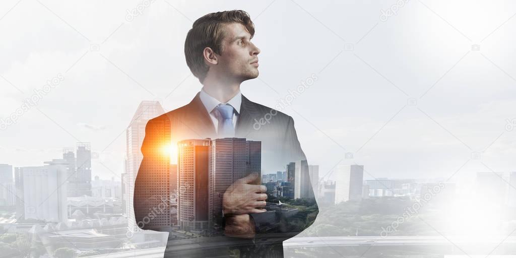 Businessman against modern city background . Mixed media