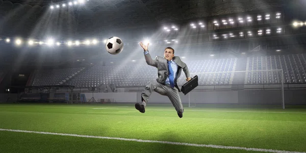 Businessman playing soccer . Mixed media — Stock Photo, Image