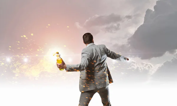 Businessman throwing petrol bomb . Mixed media — Stock Photo, Image