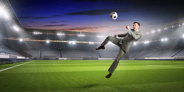 Businessman playing soccer . Mixed media — Stock Photo, Image