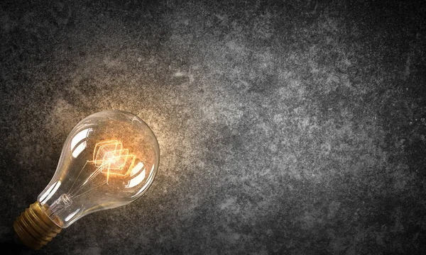 Elektrisk glödlampa på konsistens. Mixed media — Stockfoto