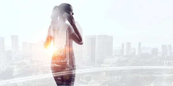 Businesswoman against modern city background . Mixed media — Stock Photo, Image