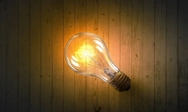 Lamp op een houten oppervlak. Mixed media — Stockfoto