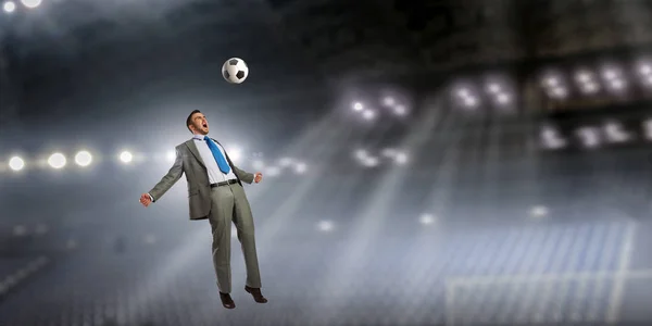 Бизнесмен играет в футбол. Смешанные медиа — стоковое фото