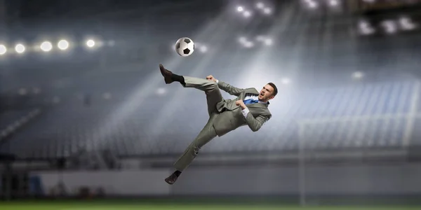 Businessman playing soccer . Mixed media — Stock Photo, Image