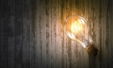 Ahşap yüzey üzerinde ampul. Karışık teknik