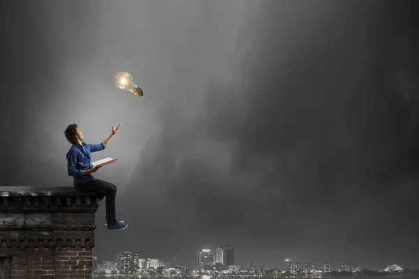 Young man with book . Mixed media — Stock Photo, Image