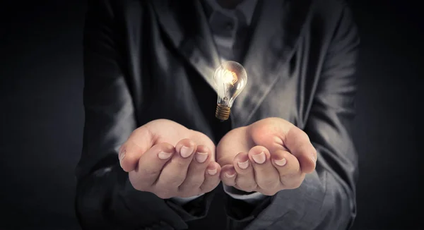 Elektrische lamp in vrouw hand. Mixed media — Stockfoto