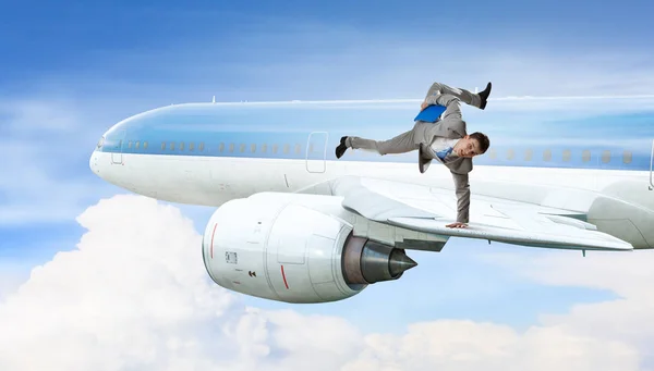 Young businessman breakdancer . Mixed media — Stock Photo, Image