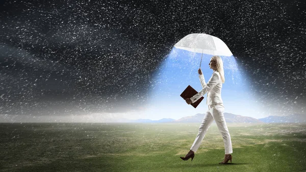 Businesswoman with white umbrella . Mixed media — Stock Photo, Image