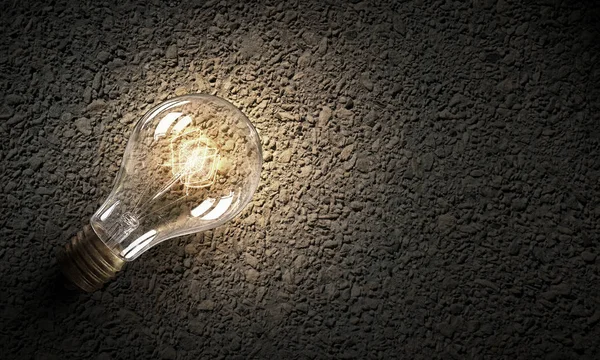 Electric bulb on texture . Mixed media — Stock Photo, Image