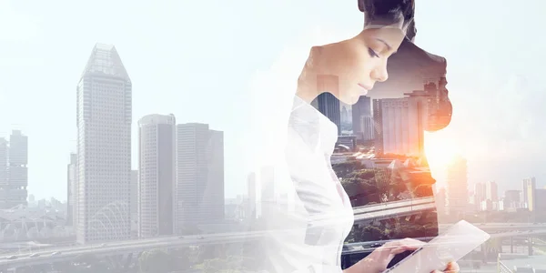 Attractive business lady working on tablet . Mixed media — Stock Photo, Image