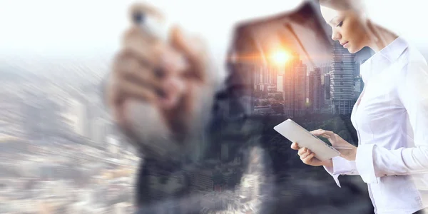 Attractive business lady working on tablet . Mixed media — Stock Photo, Image