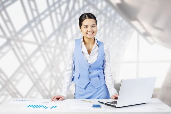 Businesswoman at office desk . Mixed media — Stock Photo, Image