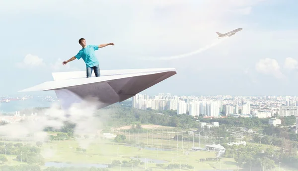 Hipster guy surfing sky . Mixed media — Stock Photo, Image