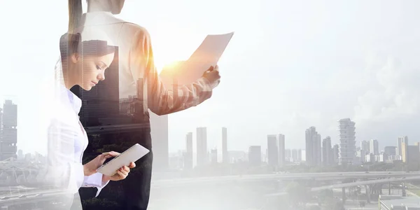 Attractive business lady working on tablet . Mixed media — Stock Photo, Image