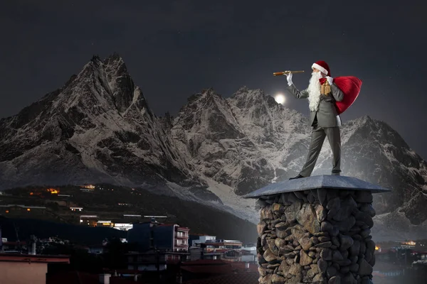 Businessman in Santa hat . Mixed media — Stock Photo, Image