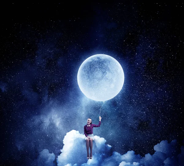 Woman sitting on cloud . Mixed media — Stock Photo, Image