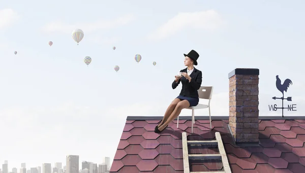 Woman banker on house top . Mixed media — Stock Photo, Image