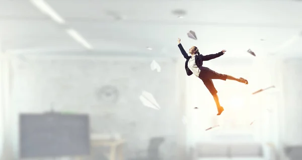 Dancing businesswoman in office . Mixed media . Mixed media — Stock Photo, Image