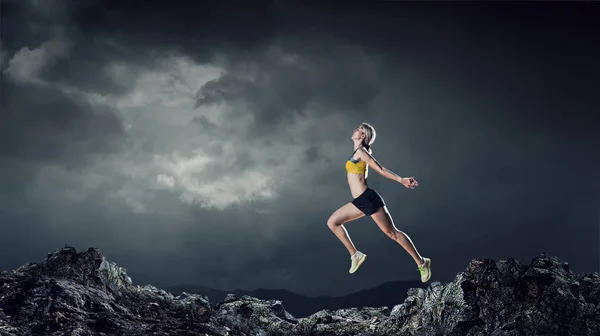 Young woman jogger . Mixed media — Stock Photo, Image