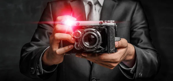 Man with camera in hands . Mixed media — Stock Photo, Image