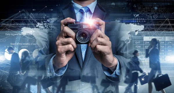 Man with camera in hands . Mixed media — Stock Photo, Image