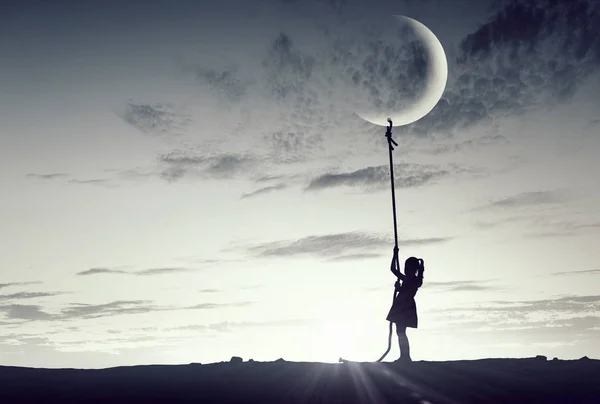 Kid girl catching moon — Stock Photo, Image