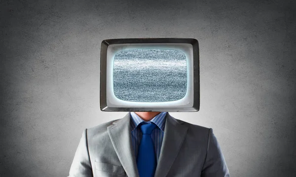 Man with TV instead of head . Mixed media — Stock Photo, Image