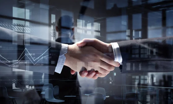 Partners shaking hands as symbol of deal — Stock Photo, Image