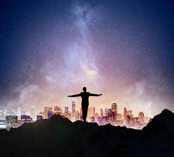 Businessman against starry sky . Mixed media — Stock Photo, Image