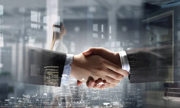 Partners shaking hands as symbol of deal — Stock Photo, Image