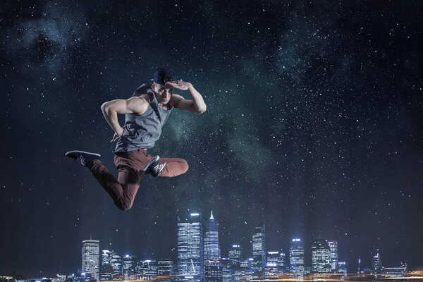 B-boy performing some moves . Mixed media . Mixed media