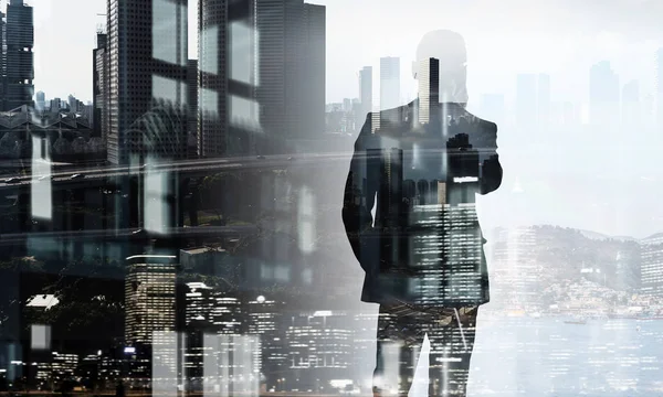 Businessman in big city . Mixed media — Stock Photo, Image