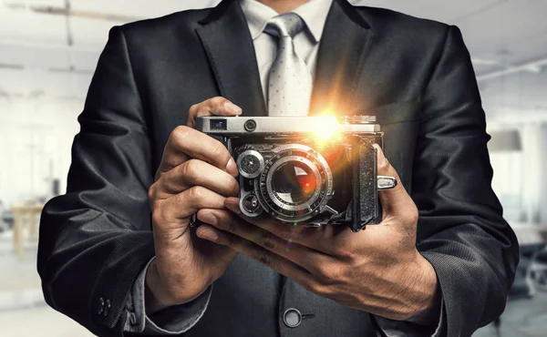 男人用手中的相机。混合媒体 — 图库照片